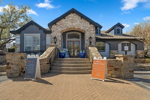 the front of a house with steps and a sign in front